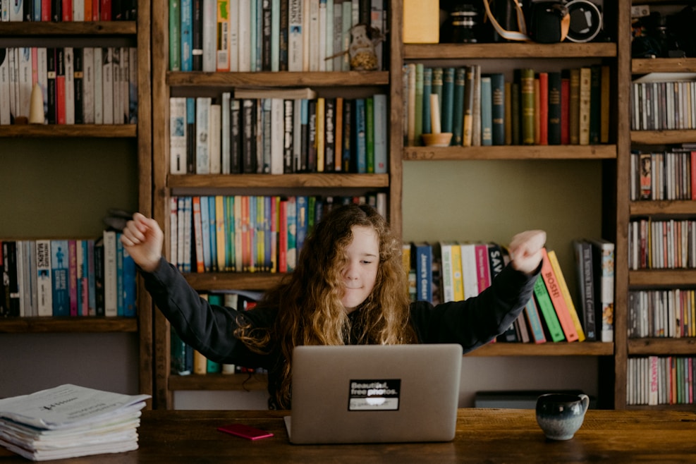 Student cheering while doing homework