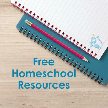 Spiral notebooks and a red pencil on a wooden desk with text 'Free Homeschool Resources'