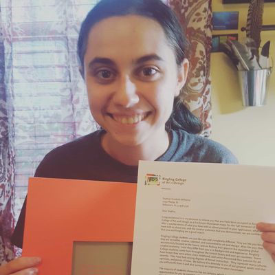 Michelle holding her degree